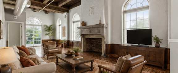 A living room with a fireplace and a couch.