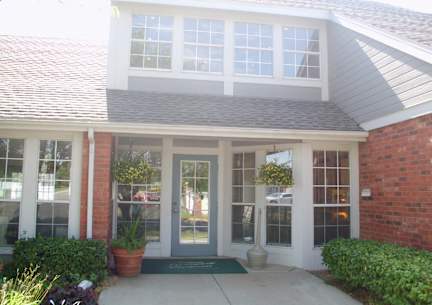 The Northpark Apartments clubhouse exterior with a pathway leading to the entrance.