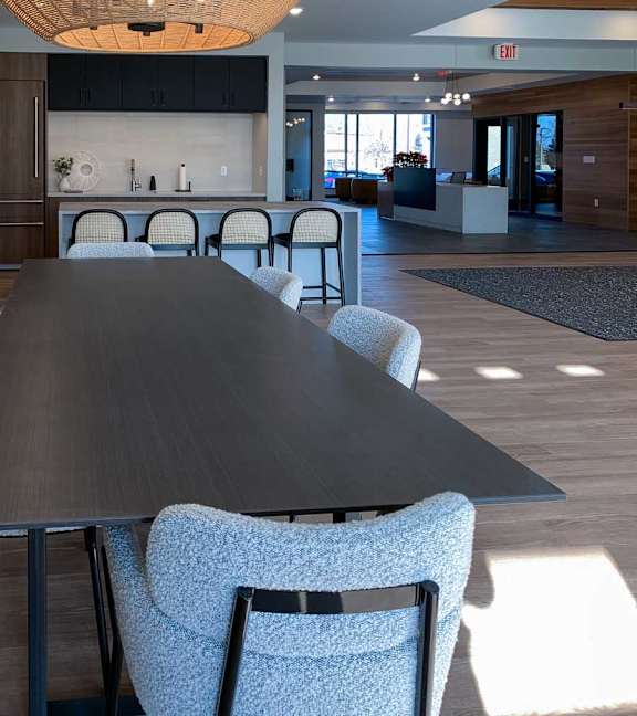 a large dining table in the community clubroom for residents to use