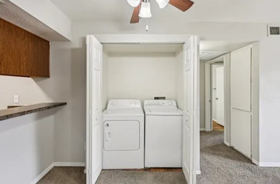 A laundry room with a washer and dryer in it.