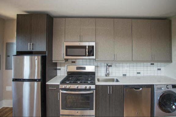 a kitchen with stainless steel appliances and wooden cabinets
