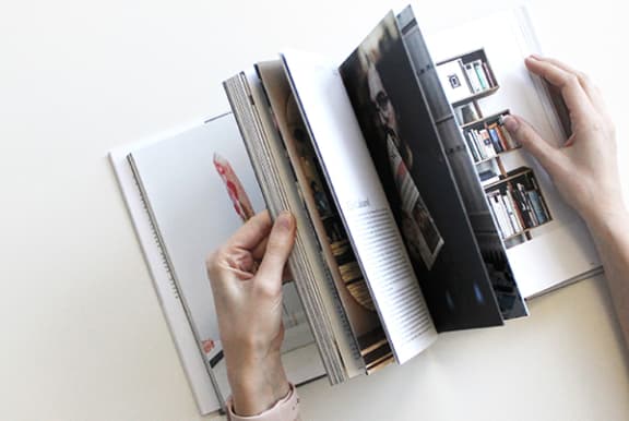 a photo of a person holding a book open