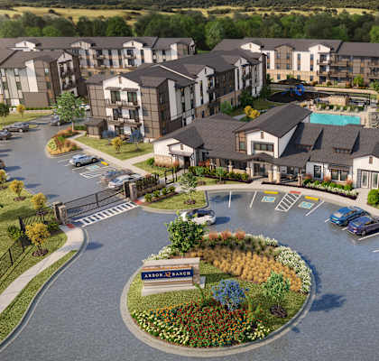 A large apartment complex with a roundabout in front.
