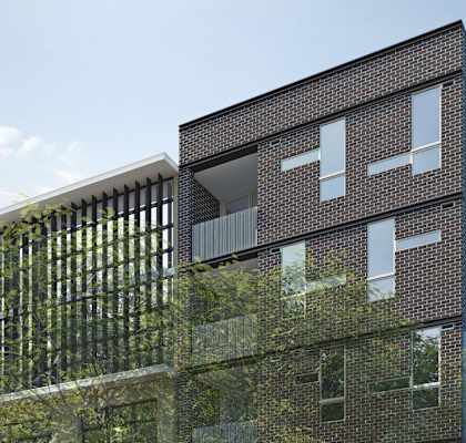 a tall brick building with a tree in front of it