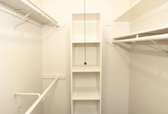 A white closet with a hanging rod and shelves.