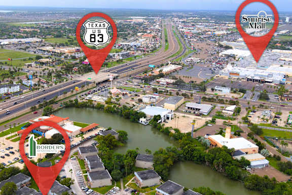 An aerial view of a town with a highway and a Sunrise Mall.