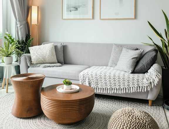 a living room with a couch and a ceiling fan