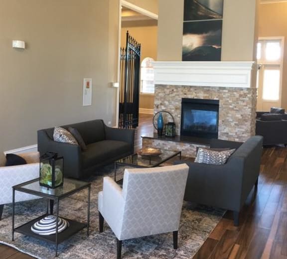 a living room with couches and chairs and a fireplace at Remington Apartment Homes, Romeoville, Illinois