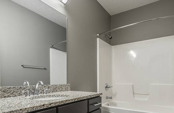 Bathroom with spacious vanity for storage and granite counters
