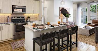 A kitchen with a bar area and a dining table.