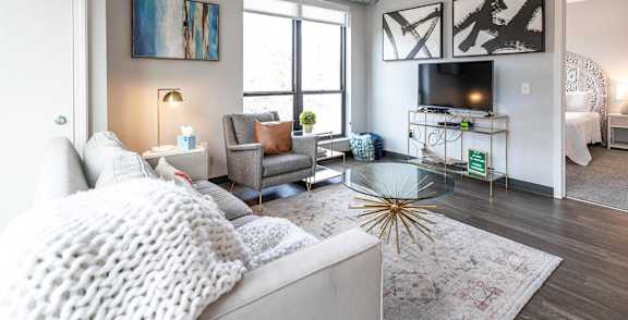 a living room with a couch and a tv at Soll, Des Moines