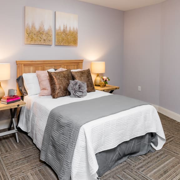 a bedroom with a bed and a large window