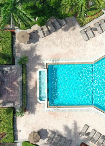 Overivew drone shot of pool area and sun deck