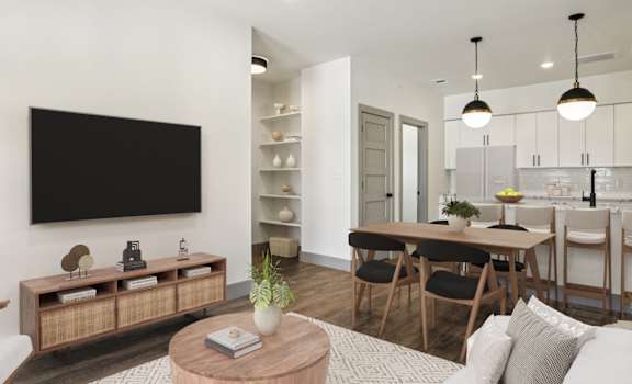 A modern living room with a flat screen TV mounted on the wall.