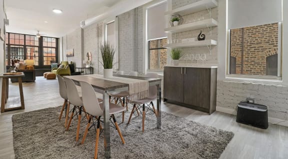 a group of chairs and a table in a room with a book shelf