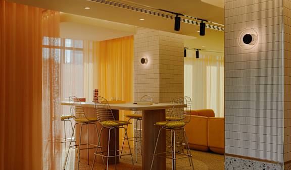 A kitchen with a table and chairs.
