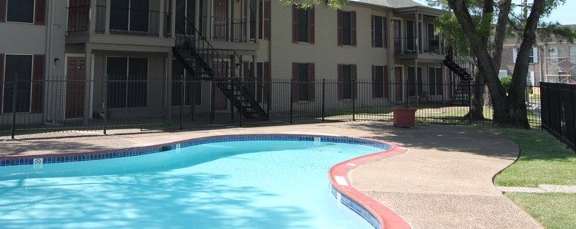 a large swimming pool in front of a building