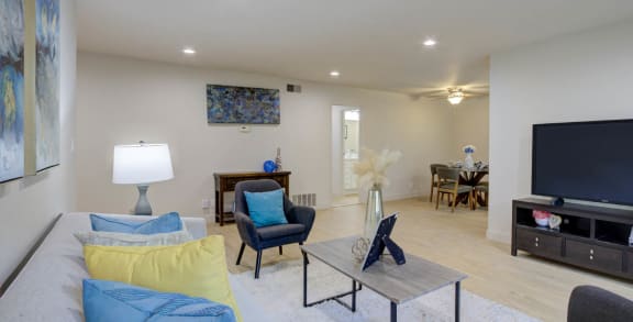 a living room filled with furniture and a flat screen tv