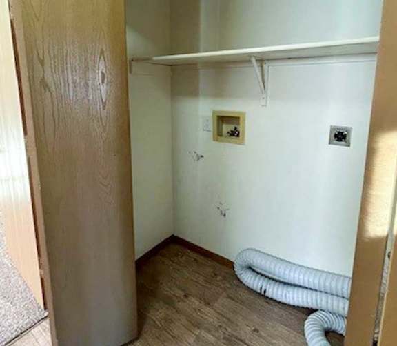 a laundry closet with washer and dryer hookups