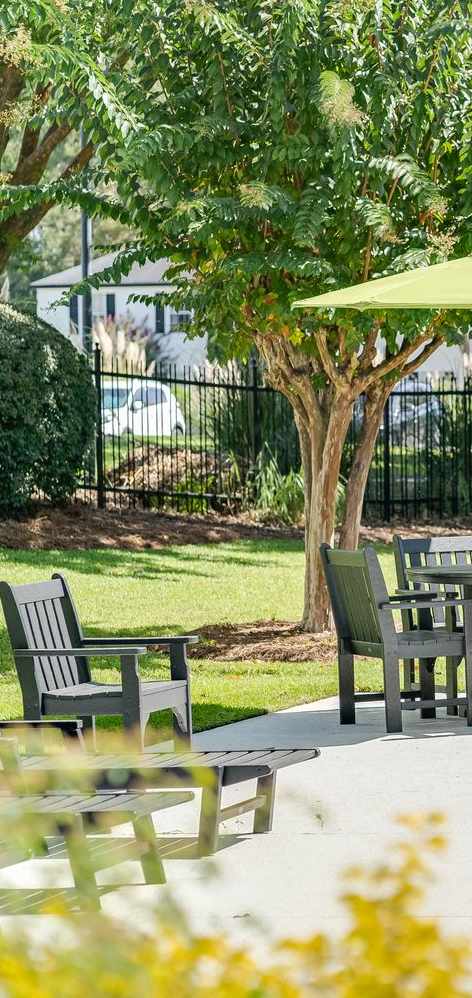A patio with a table and chairs and a pool. at Dothan Farms, Dothan, AL, 36305