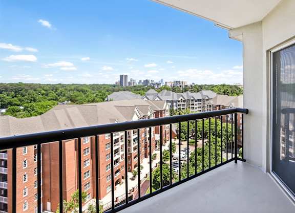 A balcony with a view of a city skyline.