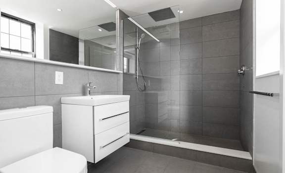 Newly renovated bathroom with great natural light and an extra large mirror