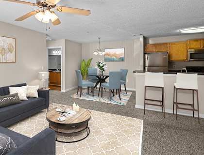 a living room with a couch and a coffee table and a dining room and kitchen