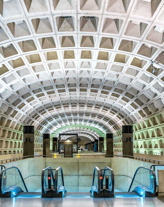 Subway station with a white ceiling and a row of escalators at Gardens of Traville, Maryland