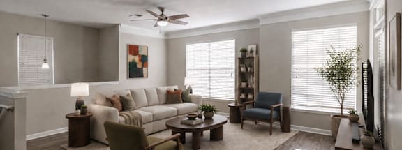 A living room with a white ceiling fan and a grey couch.