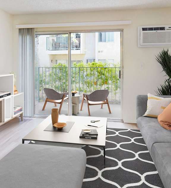 a living room with a blue couch and a patio door at Village Pointe Apartments, Northridge, CA, 91325