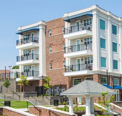 A large apartment building with a gazebo in front at Lofts at Southside in Durham, NC