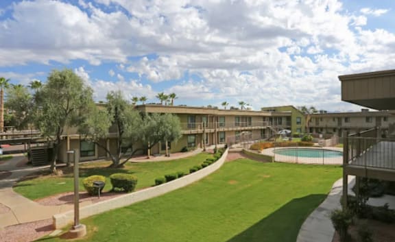 A large grassy area in front of apartment buildings.