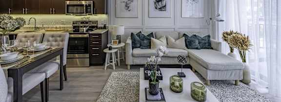 a living room with a couch and a table with a vase of flowers on it