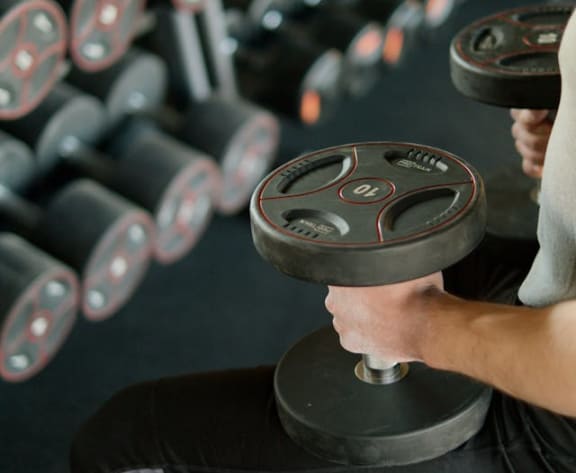 Fitness center with free weights and cardio machines at Cahill House Senior apartments in St. Louis, MO