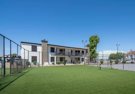 A modern building with a green lawn in front.