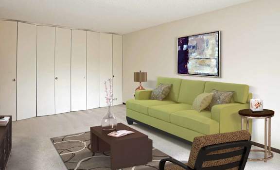 a living room with a green couch and a brown coffee table