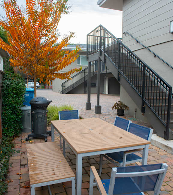 A table and chairs set up on a patio.