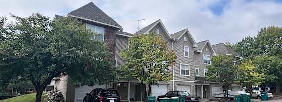 A parking lot in front of a residential building.