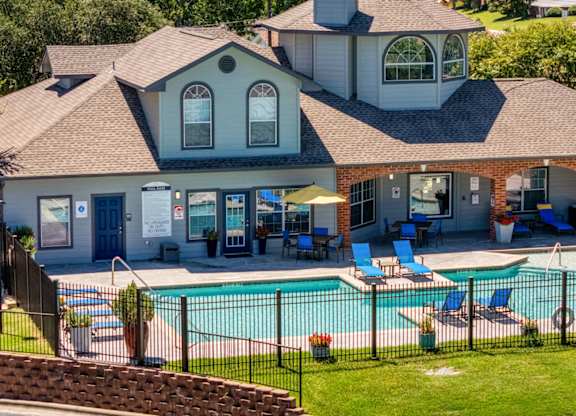 A house with a pool in the backyard at Clear Creek Meadows Apartments, Texas, 76522