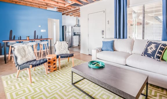 A living room with a white couch and a wooden coffee table.