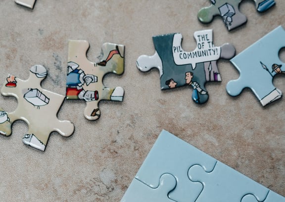 a pile of puzzle pieces sitting on top of a table