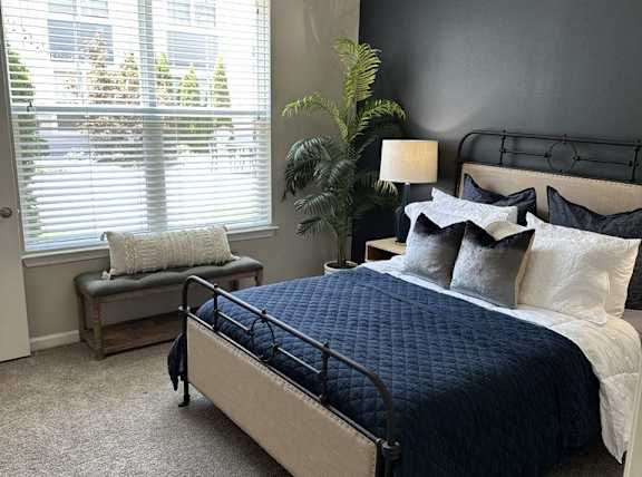 a bedroom with a bed and two windows at Watermark at Steele Crossing, Arkansas, 72703