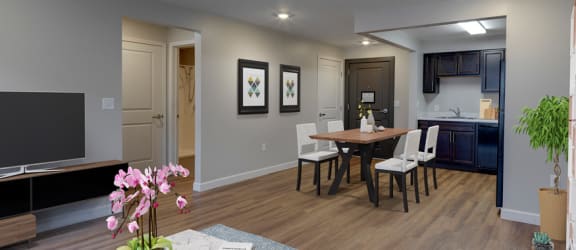 a living room and dining room with a large tv and a kitchen in the background at Meadows Senior Living Apartments, New Hartford, NY, 13413