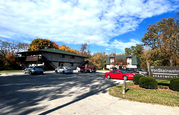 a view of the parking lot and entrance to vaughnheim apartments