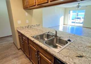 a kitchen with wooden cabinets and updated countertops