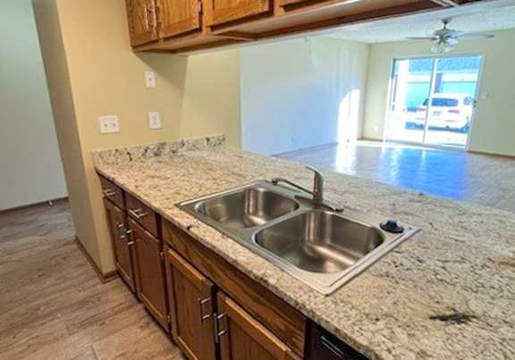 a kitchen with wooden cabinets and updated countertops