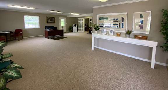 A room with a white bench and a carpeted floor.