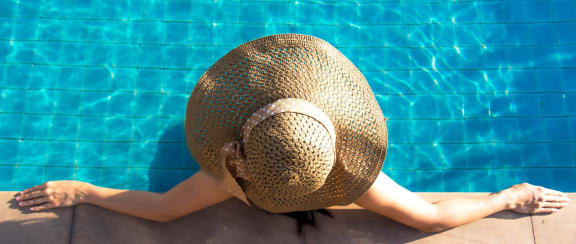 Resident Lounging in Pool at The Dakota Apartments, Jupiter, FL
