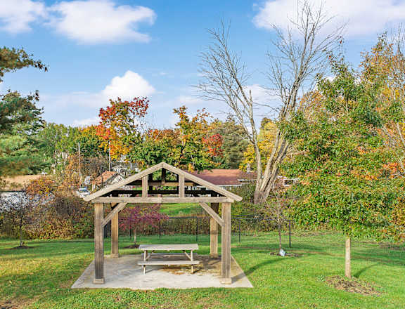 a picnic area with a bench in a park