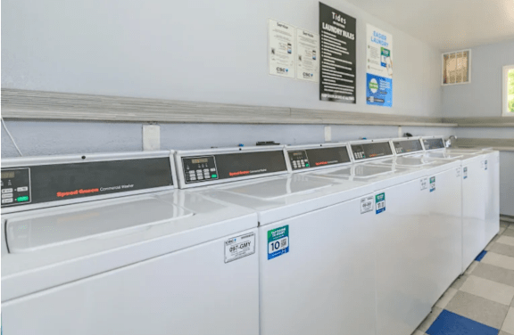 A row of washing machines in a laundromat.